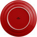 A red Tuxton Concentrix china plate with a white rim.