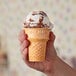 A hand holding a Keebler Eat-It-All cake cone.