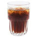 A Libbey short stackable beverage glass filled with brown liquid and ice.