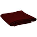 A folded burgundy Intedge round cloth table cover on a white background.