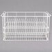 A white wire rack with compartments for dinner plates.