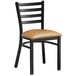 A black Lancaster Table & Seating chair with a light brown vinyl padded seat and ladder back.