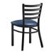 A black Lancaster Table & Seating metal chair with a navy vinyl padded seat.