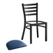 A black Lancaster Table & Seating ladder back chair with a navy vinyl padded seat.