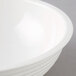A close up of a white Cambro ribbed bowl.