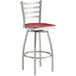 A Lancaster Table & Seating red and silver swivel bar stool with mahogany wood seat.
