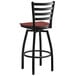A black Lancaster Table & Seating bar stool with a mahogany wood seat