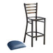 A Lancaster Table & Seating metal bar stool with a distressed copper finish and a navy blue cushion.