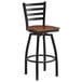 A Lancaster Table & Seating black ladder back bar stool with a wooden seat.
