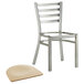 A Lancaster Table & Seating metal ladder back chair with a natural wood seat.