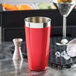 A red stainless steel Tablecraft cocktail shaker tin on a counter.