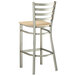 A Lancaster Table & Seating metal ladder back bar stool with a natural wood seat.