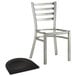 A Lancaster Table & Seating metal chair with a black wood seat on a white background.