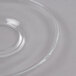 A clear glass saucer with a circular bottom.