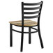 A Lancaster Table & Seating black metal chair with a driftwood seat.