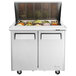 A Turbo Air stainless steel refrigerated sandwich prep table with food trays in a container.