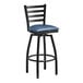 A Lancaster Table & Seating black ladder back swivel bar stool with a navy blue padded seat.