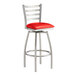 A Lancaster Table & Seating red vinyl padded bar stool with silver legs.