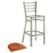 A Lancaster Table & Seating metal bar stool with a cherry wood seat.