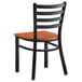 A black Lancaster Table & Seating ladder back chair with a wood seat.