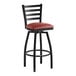 A Lancaster Table & Seating black finish ladder back swivel bar stool with a burgundy padded seat.