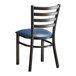 A Lancaster Table & Seating black metal ladder back chair with a navy blue padded seat.
