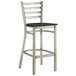 A Lancaster Table & Seating metal bar stool with a black wood seat.