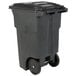 A black Toter rectangular trash can with wheels.