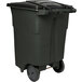 A green Toter rectangular wheeled trash can with casters and lid.