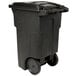 A black Toter trash can with wheels.