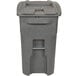 A grey plastic Toter commercial trash can with a barrel lock lid.