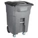 A grey Toter trash can with wheels and a black lid.