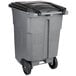 A grey Toter wheeled trash can with black lid.
