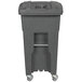 A grey plastic Toter trash can with wheels and a barrel lock lid.