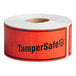 A roll of red TamperSafe labels with black text.
