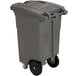 A grey Toter rectangular wheeled commercial trash can with a padlock lid.