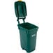 A Toter green rectangular trash can with lid open.