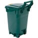 A green Toter curbside trash can with a lid.