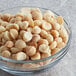 A bowl of dry roasted unsalted macadamia nuts.