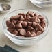A close up of a bowl of Guittard Milk Chocolate baking chips.
