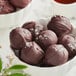 A bowl of Guittard French Vanilla dark chocolate truffles on a counter.