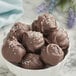 A bowl of Guittard L'Etoile du Nord 64% semi-sweet chocolate balls.