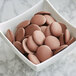 A bowl of Guittard milk chocolate wafers.