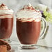 A glass mug of Guittard Grand Cacao drinking chocolate with whipped cream.