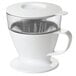 An OXO white pour over coffee dripper with a clear lid.