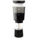 An OXO cold brew coffee maker with liquid in it on a table.