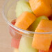 A clear Bare by Solo deli container filled with sliced fruit.