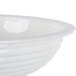 A close up of a white Cambro round ribbed bowl.