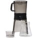 An OXO cold brew coffee maker with a clear glass beaker and black handle.