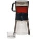 An OXO cold brew coffee maker with a glass container and a cup.